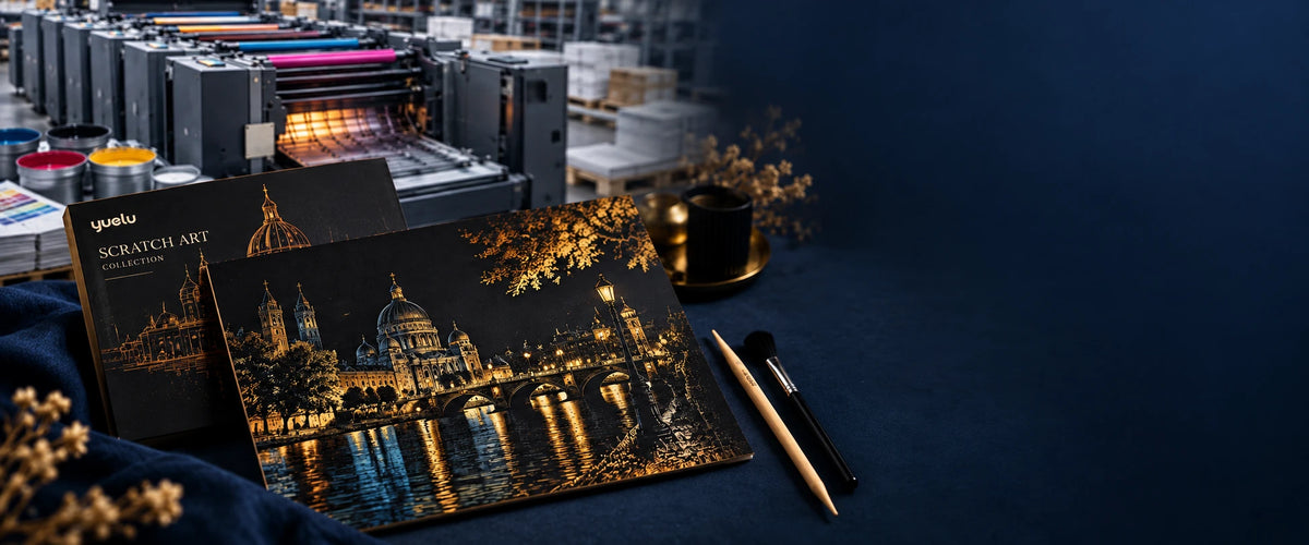 Black and gold scratch art kit with printing equipment behind it