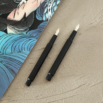 Two black scratch art pens displayed beside scratch art
