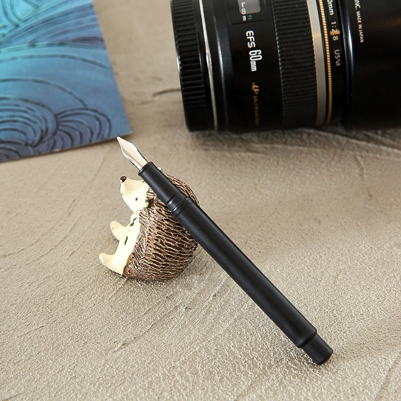 Black scratch art pen displayed on a desk
